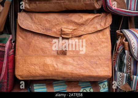 An old brown handbag displayed at a vintage fashion boutique for tourists Stock Photo