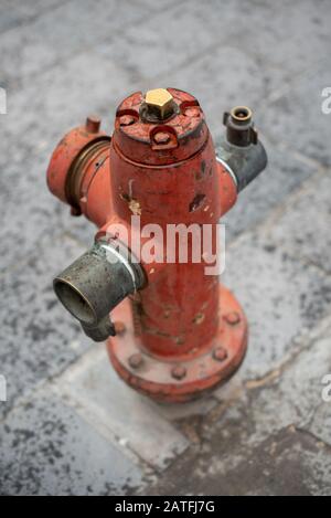 Top view of a vintage street fire hydrant seen on an isolated path in the city Stock Photo