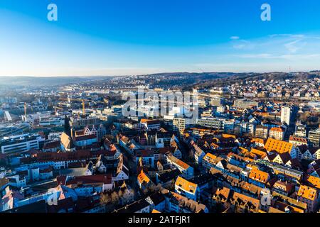 Ulm, Germany, December 29, 2019, Endless aerial view above cityscape and rails near downtown in warm sunset light Stock Photo