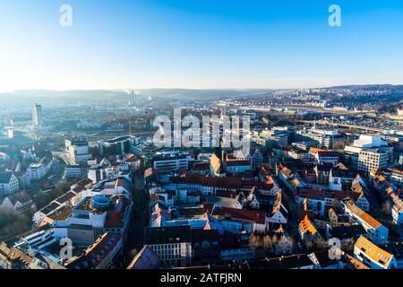 Ulm, Germany, December 29, 2019, Aerial view above cityscape and train station of downtown in warm sunset light in the evening in winter season Stock Photo