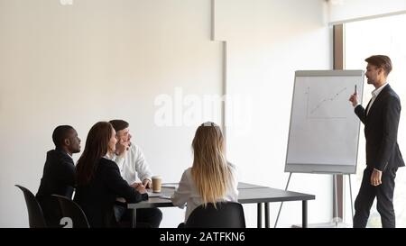 Group meeting led by business trainer in modern office boardroom Stock Photo