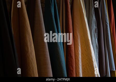 Tie-dyed fabrics from natural colors, hung on a clothesline arranged in rows. Wool Stock Photo