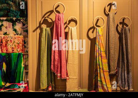 Tie-dyed fabrics from natural colors, hung on a wall. Wool Stock Photo