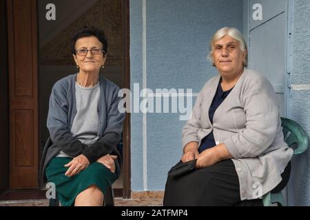 Two women in town of Gjirokaster, Albania Stock Photo