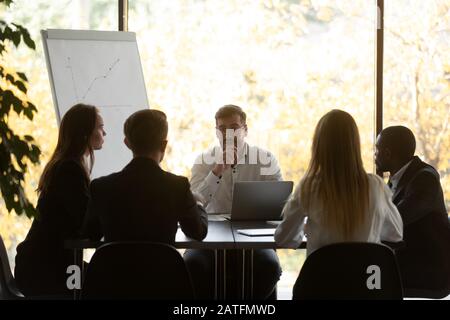 Confident businessman makes presentation for investors during group meeting Stock Photo