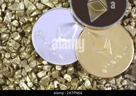 Cryptocurrency Ethereum on mound of gold nuggets. Crypto currency coins. Stock Photo