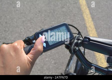 Turning on electric bike, E-bike or bicycle. Pressing a button on control  board or controller to choose speed and power level. Unfiltered, with natura  Stock Photo - Alamy