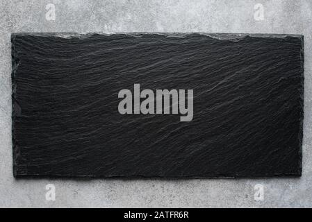 Black slate board, top view. Copy space for text. Black stone texture. Cooking cutting board for food Stock Photo