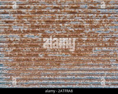 Old roller shutter showing orange rust and weathering Stock Photo