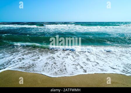 Waves of the black sea on the sandy coast of Crimea