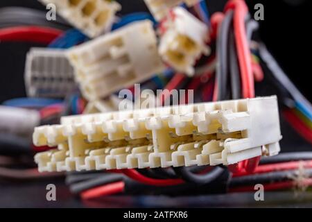 Old electrical connectors and plugs. Electrical accessories from home appliances. Dark background. Stock Photo