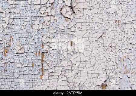 Texture of peeling white paint on a wooden wall. Surface with worn material. Stock Photo