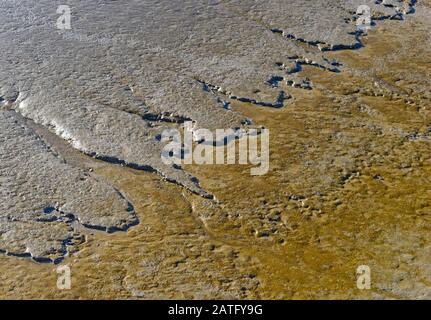 The mud, exposed at low tide, in Watchet harbour, Somerset, UK, looks like a satellite image of an unknown land Stock Photo