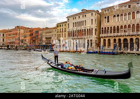 Two people taking a gondola ride near the Rialto bridge in Venice,Italy Stock Photo