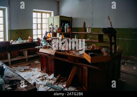 Abandoned ruined chemical laboratory. Old broken glassware Stock Photo