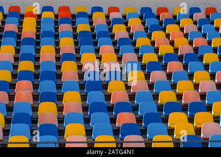 Blue and orange stadium plastic seats. Colorful texture Stock Photo