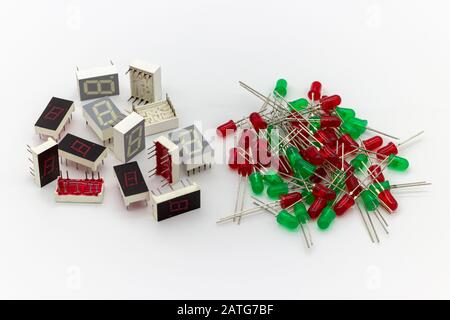 Electronic components. Old 7 segments single digit led display and red and green leds on white background. Stock Photo