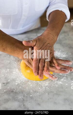 Italian woman kneading homemade pasta dough Stock Photo
