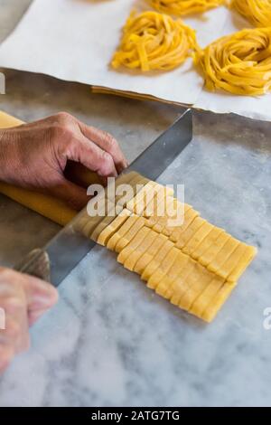 Italian woman making homemade Tagliatelle  pasta Stock Photo