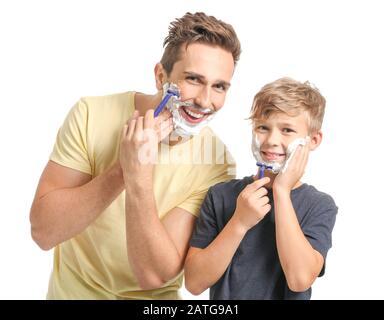 Father and his little son shaving against white background Stock Photo