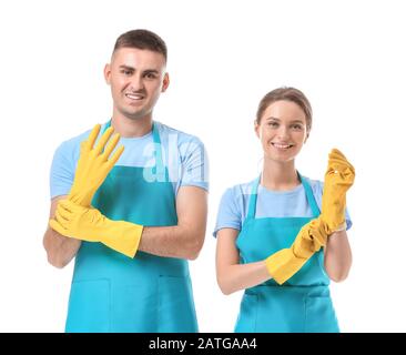 Portrait of janitors putting on rubber gloves against white background Stock Photo