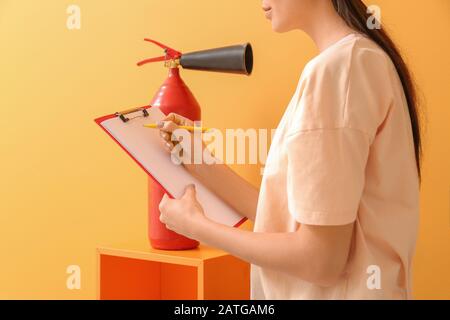 Fire safety specialist inspecting extinguisher Stock Photo