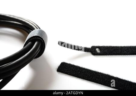 black velcro cable tie and cable on white Stock Photo