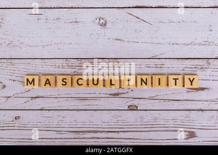 Masculinity text on wood blocks, wooden background. Stock Photo