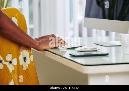 Cropped image of woman sending e-mails to her coworkers, relatives and friends Stock Photo