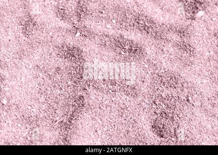 Beach sand texture close-up. Natural background pink color toned Stock Photo