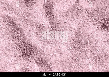 Beach sand texture close-up. Natural background pink color toned Stock Photo