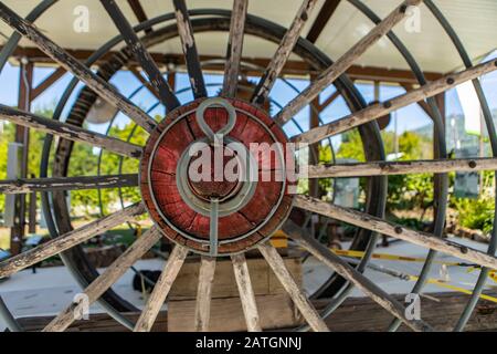 Antique wooden wagon wheels. Rusty wheels in the agriculture museum used in agricultural works. Kootenays, British Columbia, Canada Stock Photo