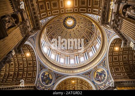 This is the main dome in St. Peter's Basilica. The top of the dome is 448 feet above the floor. The tallest dome in the world. All those panels that l Stock Photo