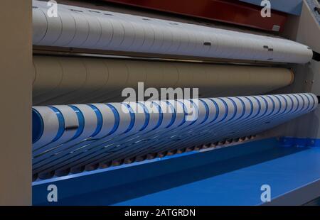 An industrial ironer machine for laundry ; hotel industrial background Stock Photo