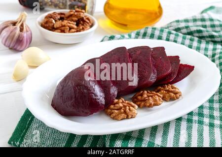 Slices of boiled beets on a white plate. Source of energy. Dietary healthy vegetable. Stock Photo