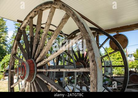 Old wooden wagon wheels used in the agricultural works. Rusty wheels in the agriculture museum in Kootenays, British Columbia, Canada Stock Photo