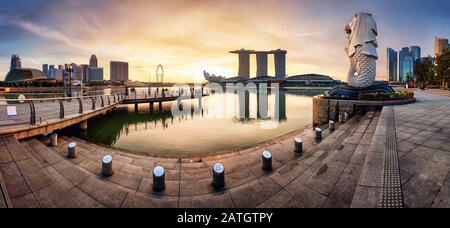 SINGAPORE - OCTOBER 11 2019: Merlion fountain and marina bay sands panorama is famous landmark at sunrise of Singapore city