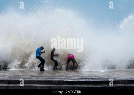 Worli sea face, Kids enjoying the water spray caused by waves breaking, Mumbai, India Stock Photo