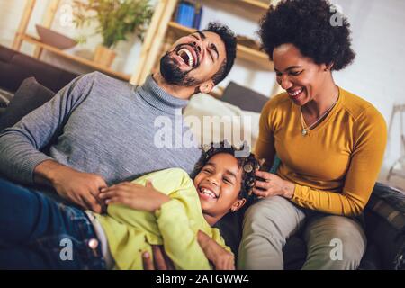 Happy african american family having fun at home. Stock Photo