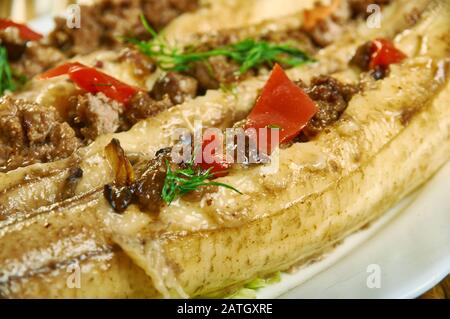 Puerto Rican  Stuffed Baked Plantains, roasted plantains filled with seasoned ground meat, tomatoes, onions, bell pepper, and spices Stock Photo