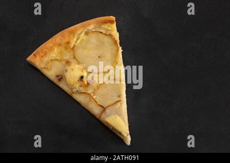 Dietary pizza with pear, walnuts and gorgonzola on black stone plate. Stock Photo