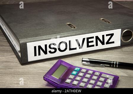 A calculator and folder with bankruptcy papers Stock Photo