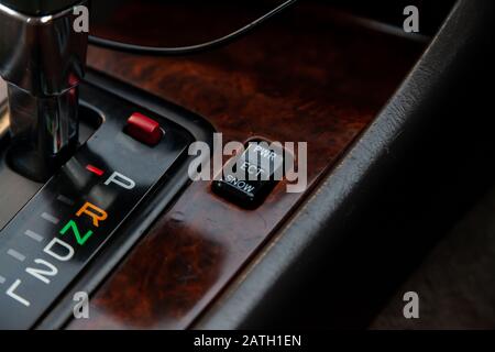 The car panel is next to the speed switch with letters designating the gears and the transmission control buttons and the stabilization system. Stock Photo