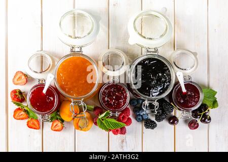 Selection of berry jams in glass jars Stock Photo