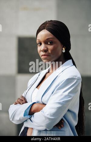 Serious young confident Black businesswoman folding arms and looking at camera Stock Photo