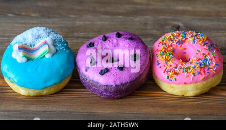 Assortment of donuts on wooden background Stock Photo