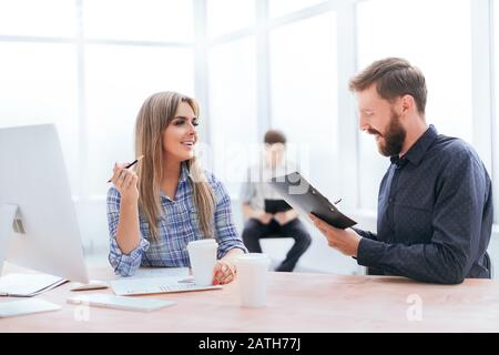 smiling staff discussing business document during coffee break Stock Photo