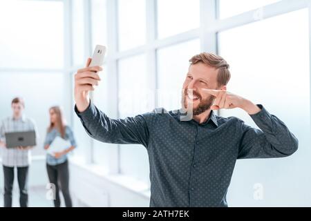 happy businessman talking via video chat on his smartphone Stock Photo