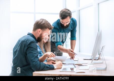 happy business colleagues shaking hands in the workplace Stock Photo