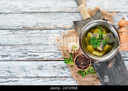 Trout fish soup. Ukrainian cuisine. Top view. Free space for your text. Rustic style. Stock Photo